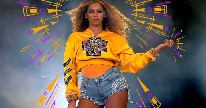Beyonce on stage in yellow cropped sweater